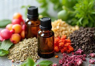 Close-up image displaying a variety of colorful, fresh natural ingredients like herbs, dried flowers, and small bottles of oils.